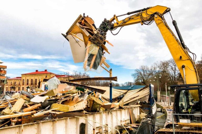 house demolition in Brisbane by a yellow excavator