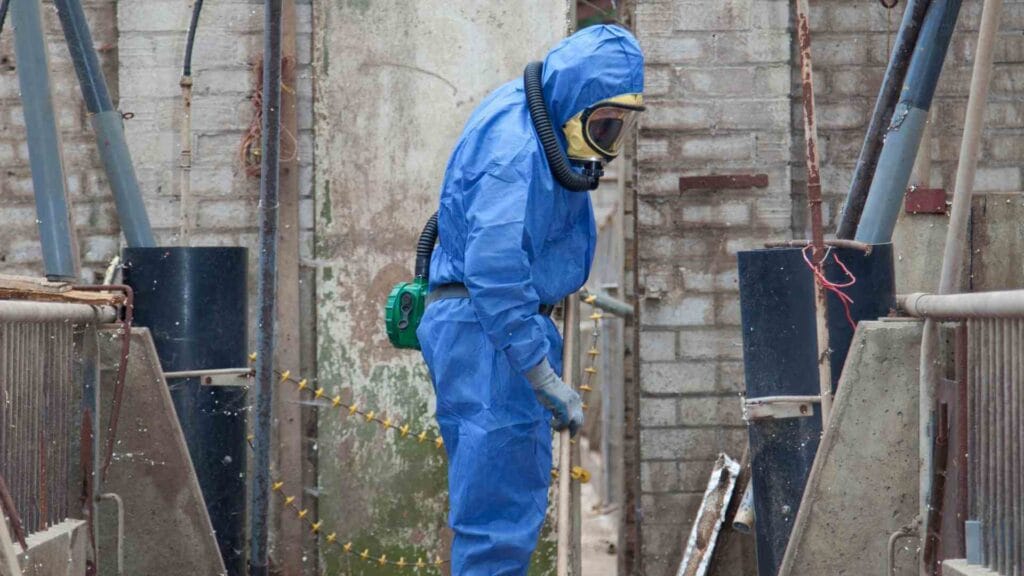 Asbestos removalist in a full PPE suit